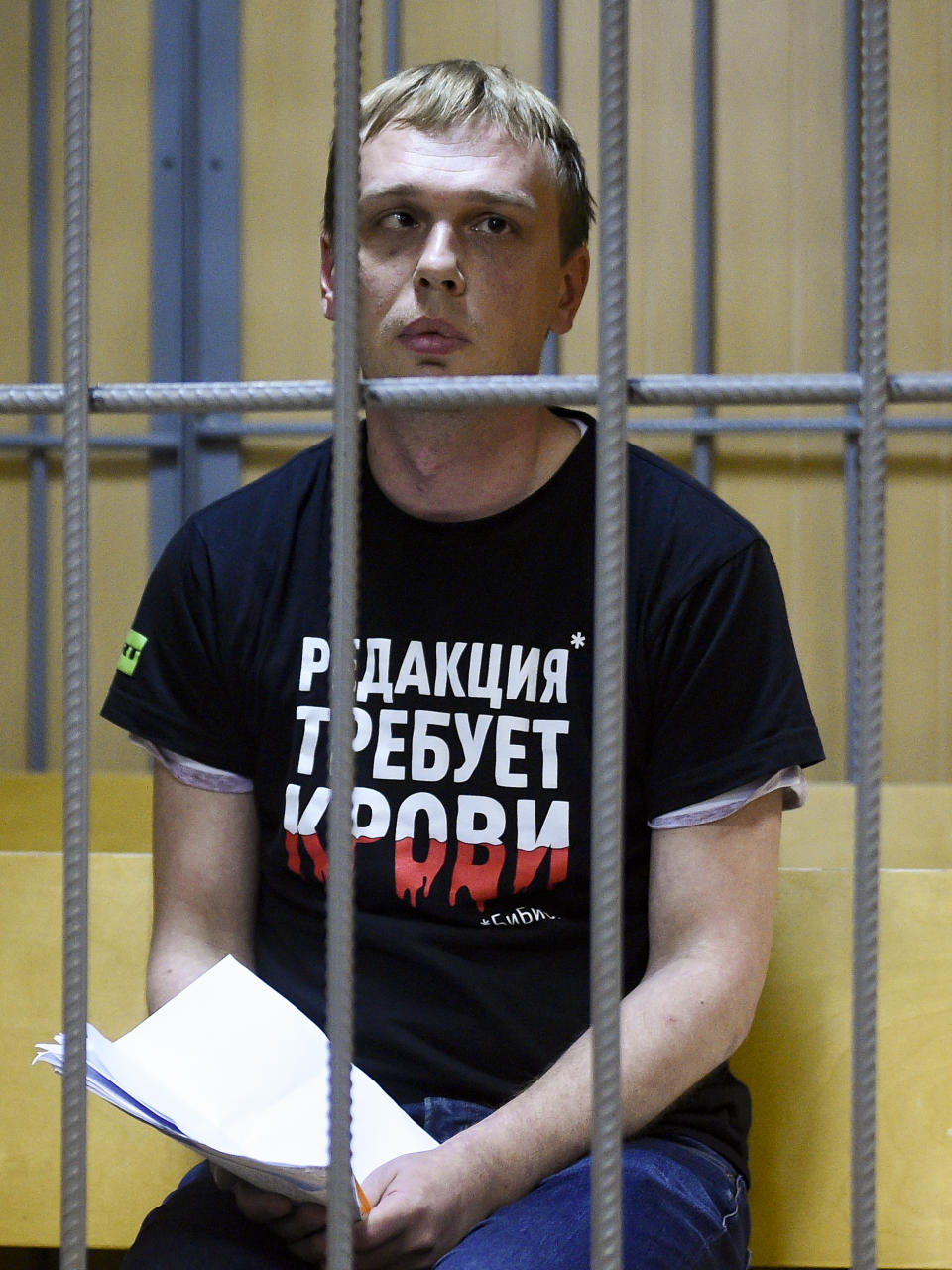 Ivan Golunov, a journalist who worked for the independent website Meduza, sits in a cage in a court room in Moscow, Russia, Saturday, June 8, 2019. A prominent investigative journalist who was detained on drug-dealing charges in Russia is being taken to the hospital after complaining of feeling poorly in police custody. (AP Photo/Dmitry Serebryakov)