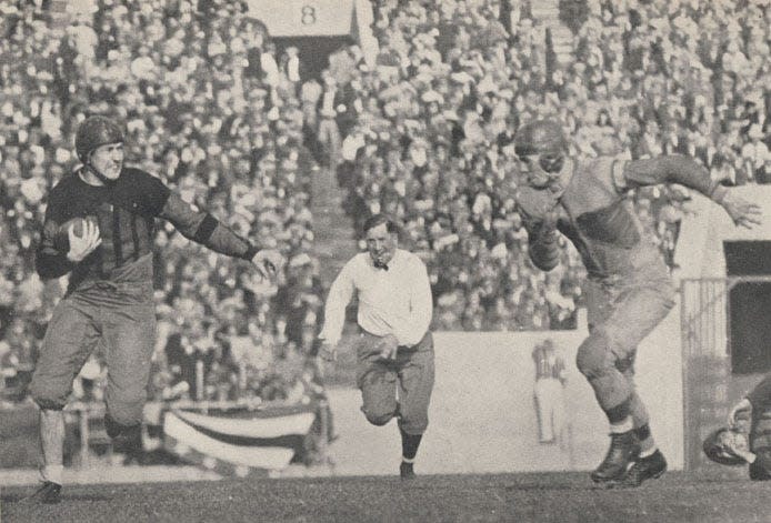 Alabama’s Johnny Mack Brown runs for a gain while being pursued by a Washington defender during the 1926 Rose Bowl in Pasadena, Calif. Alabama defeated the Huskies, 20-19, to win its first national championship.