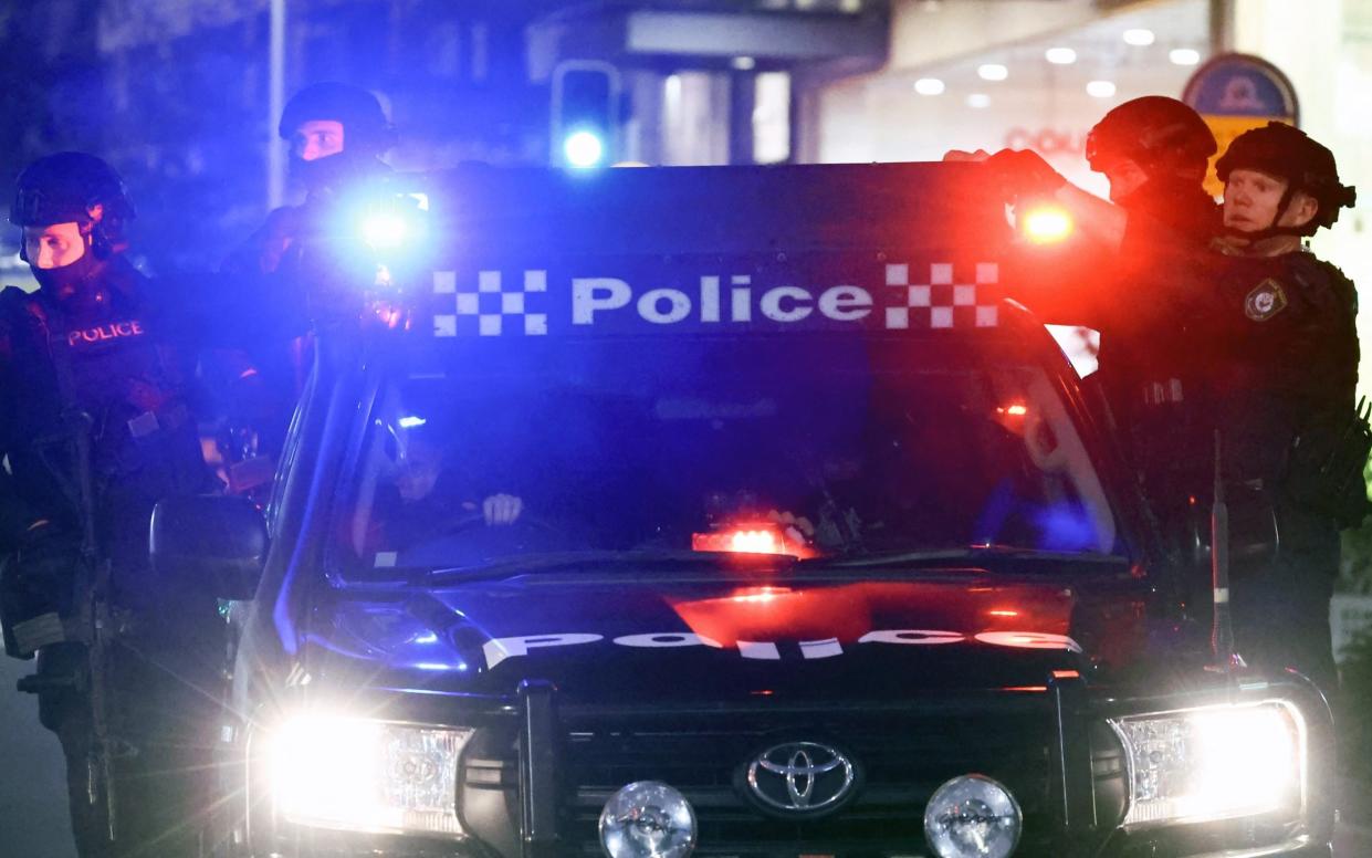 Police patrol near the crime scene in front of the Westfield Bondi Junction shopping mall