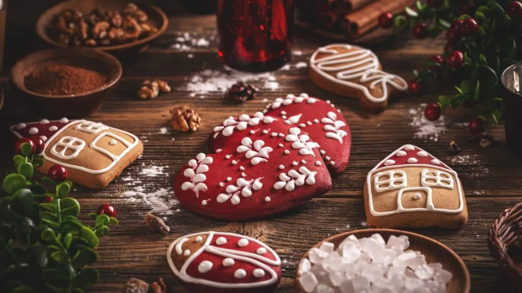 Glazed gingerbread homemade cookies on wooden background