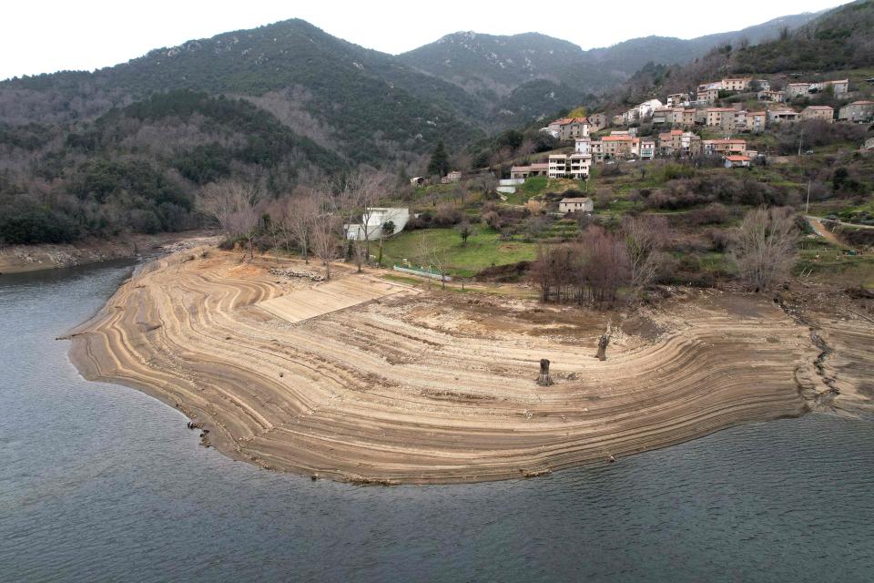 This aerial photograph taken on February 24, 2023, shows the low water level of the Tolla lake, on the French Mediterranean Island of Corsica. France has not seen any significant rainfall for more than 31 days, "Meteo-France" confirmed on  February 21. Around France, residents are sharing images of dried-up riverbeds or shrunken lakes – shocking sights in the depths of winter.