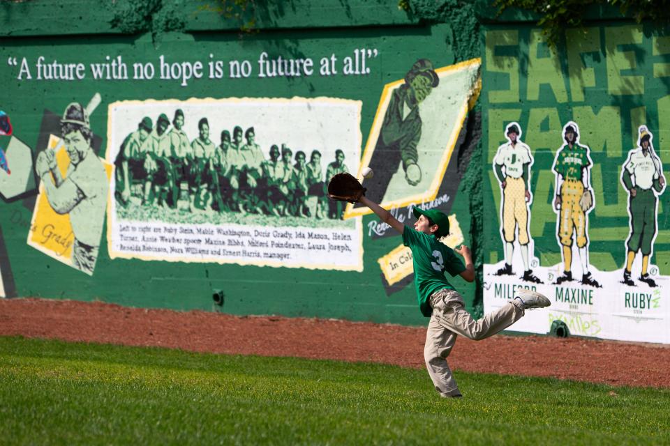 Anthony Vasoli, 9, plays catch with his father, Matteo, during the unveiling of murals at a new public baseball field, Foundry Field, on Monday, May 20, 2024, in South Bend.