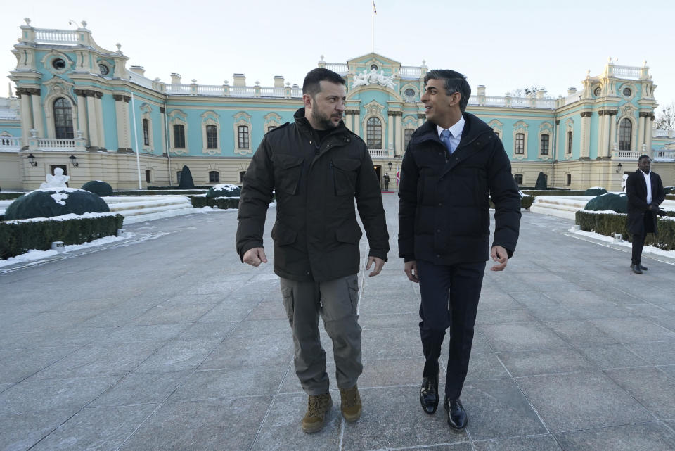 Prime Minister Rishi Sunak walks beside President Volodymyr Zelenskyy during a visit to the Presidential Palace in Kyiv, Ukraine, to announce a major new package of £2.5 billion in military aid to the country over the coming year, Friday, Jan. 12, 2024. (Stefan Rousseau/Pool via AP)