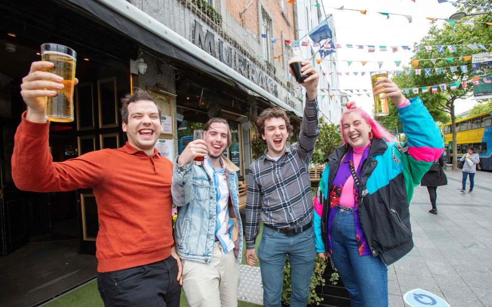 Drinkers in Dublin celebrate last month after pubs that sell food open again - but now drinking-only outlets are to stay closed after a setback in the fight against Covid-19 - Paul Faith /AFP