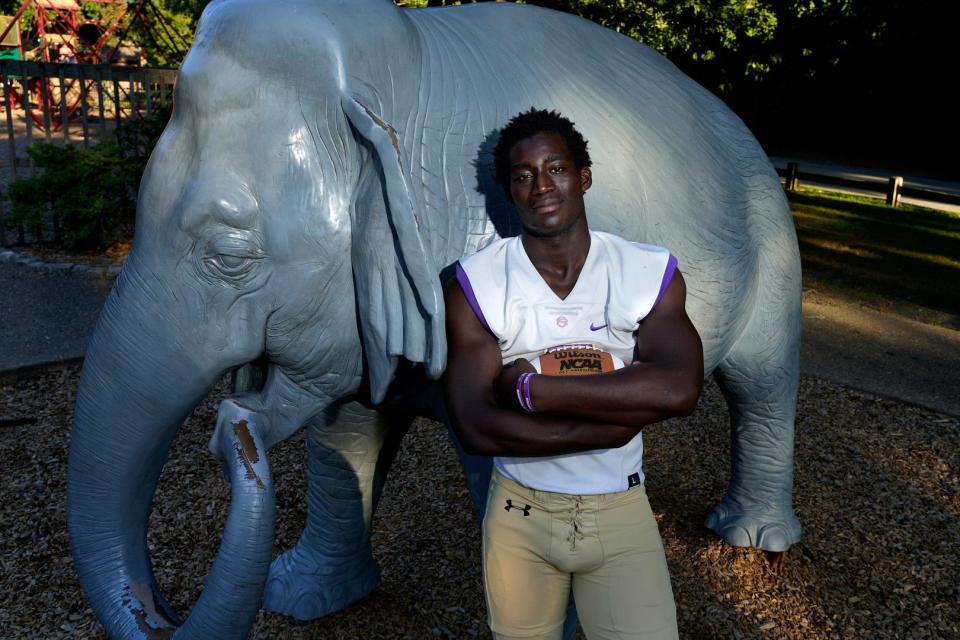 St. Raphael All-Stater Moses Meus poses with Fanny the Elephant in Slater Park as part of a Providence Journal feature prior the the 2022 high school football season.