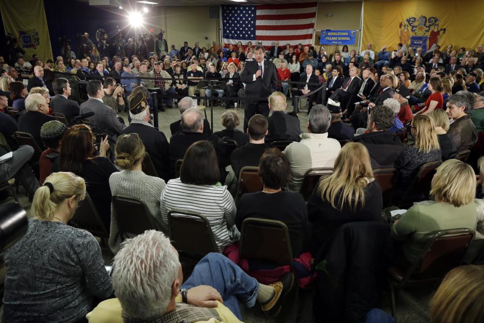 Gov. Chris Christie, center, addresses a large gathering Thursday, Feb. 20, 2014, in Middletown, N.J., during a town hall meeting. Christie returned to Republican-controlled Monmouth County on Thursday for his first town hall since private emails revealed a political payback scandal in which his associates ordered traffic lanes closed, causing lengthy backups. But the scandal didn't come up. Instead, the 51-year-old Republican heard from residents who have not returned to their homes since the 2012 storm. (AP Photo/Mel Evans)