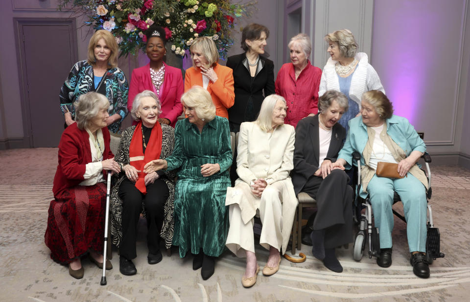 FILE - Britain's Queen Camilla, front row third left, smiles as she poses with Dames, from left, back row, Joanna Lumley, Floella Benjamin, Twiggy Lawson, Harriet Walter, Penelope Wilton, Maureen Lipman, from left. front row, Virginia McKenna, Siân Phillips, Judi Dench, Vanessa Redgrave, Penelope Keith and Patricia Routledge at the "Celebration Of Shakespeare" event, at Grosvenor House, in London, Wednesday, Feb. 14, 2024. (Chris Jackson/Pool Photo via AP, File)