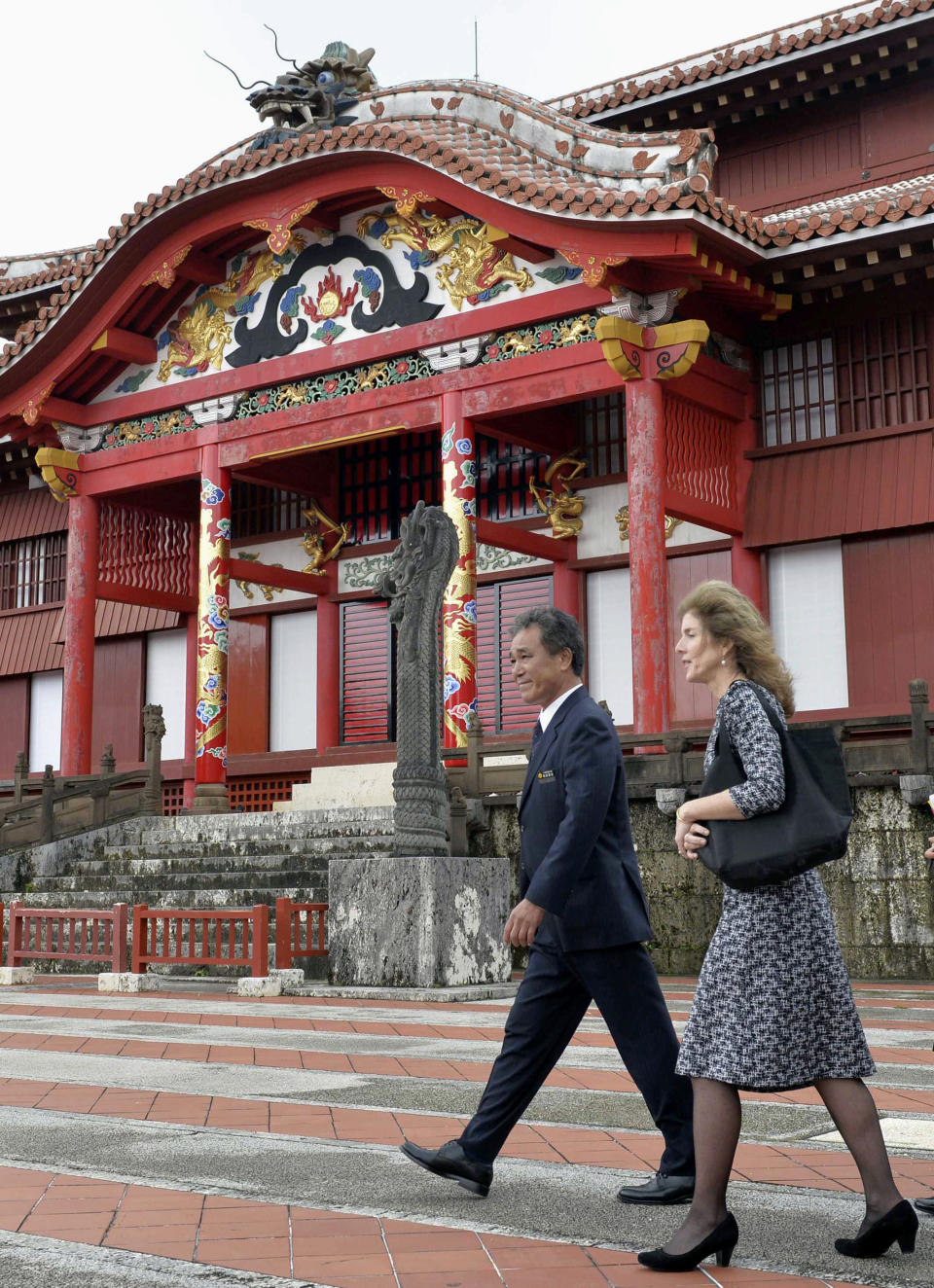 U.S. Ambassador to Japan Caroline Kennedy, right, visits Shuri castle in Naha, Okinawa Wednesday, Feb. 12, 2014. Kennedy has made her first visit to the southernmost island of Okinawa, hoping to get support for a controversial plan to relocate a U.S. military base. (AP Photo/Kyodo News) JAPAN OUT, MANDATORY CREDIT