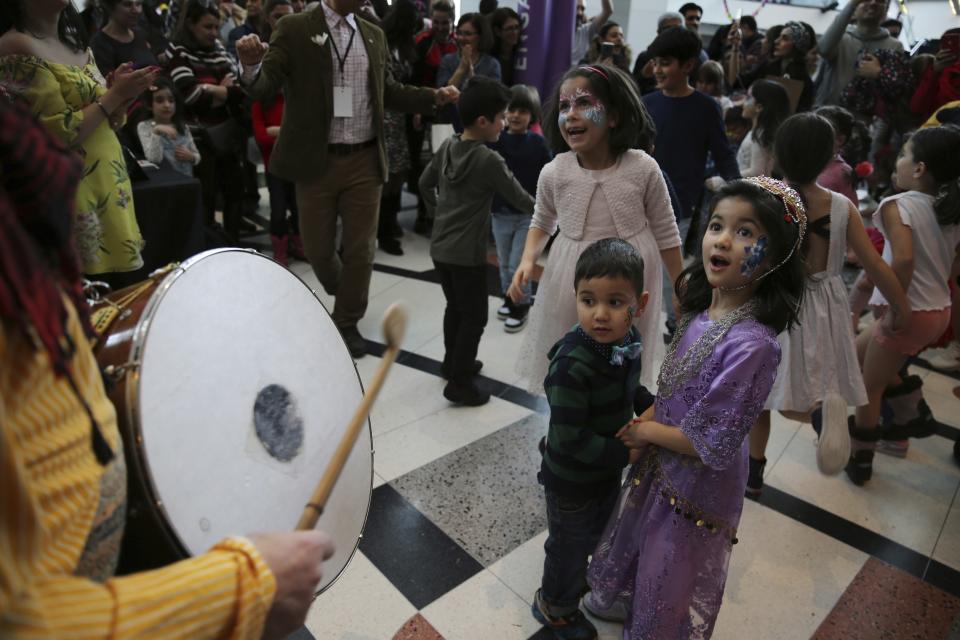 In this Saturday, March 9, 2019, Iranian-Canadian children dance with the traditional sound of Saz o Dohol, during the Tirgan Nowruz Festival in Toronto, Canada. The event aims to preserve and celebrate Iranian and Persian culture, said festival CEO Mehrdad Ariannejad. Among those who attended were second-and third-generation immigrants, many of whom have never been to Iran or have not been there since leaving the country following the 1979 Islamic Revolution. (AP Photo/Kamran Jebreili)