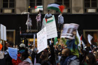 Protesters march through the streets of Chicago's Loop in support of Palestinians, Wednesday, May 12, 2021. (AP Photo/Shafkat Anowar)