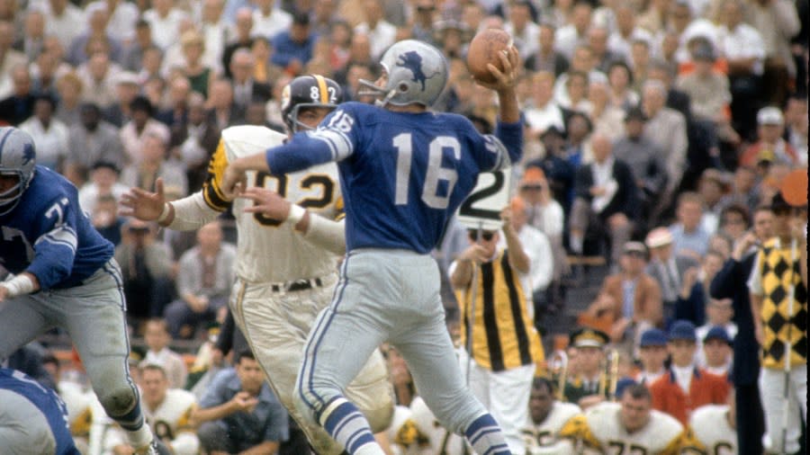 Milt Plum throws a pass as a Pittsburgh defender bares down on him.