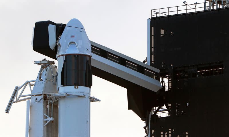 The SpaceX Crew Dragon sits atop a Falcon 9 booster rocket on Pad 39A at Kennedy Space Center before a scheduled in-flight abort test