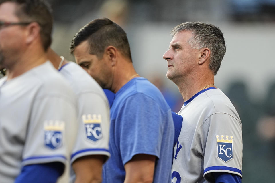 Kansas City Royals manager Matt Quatraro, right, stands by members of his staff during the playing of the national anthem before a baseball game against the Texas Rangers, April 10, 2023, in Arlington, Texas. (AP Photo/Tony Gutierrez)