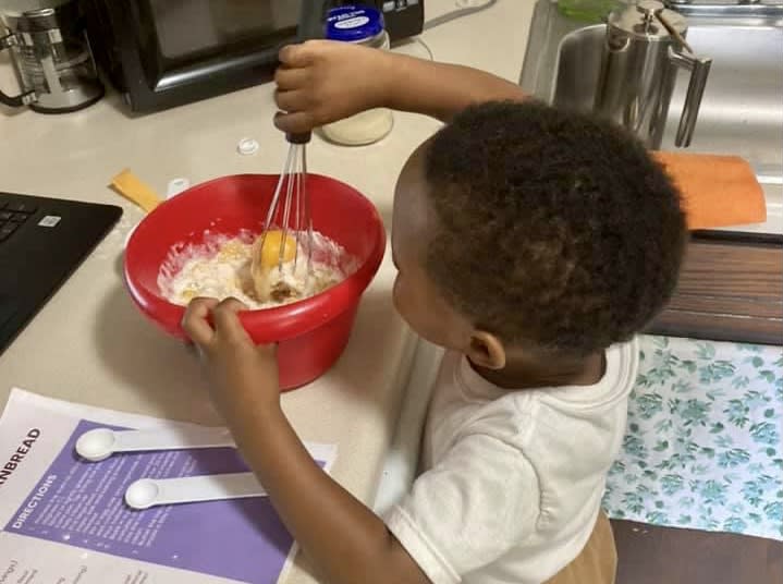 A young participant mixes batter for cornbread, part of the soul food menu children learn about on the Reconstruction platform. (Catapult Greater Pittsburgh)