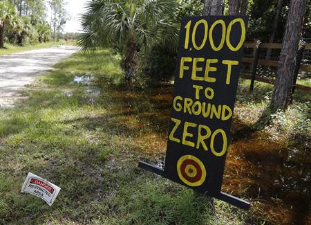 A sign placed by Jaime Duran and his wife Pamela stands in front of their home in Naples, Florida September 21, 2013. REUTERS/Joe Skipper