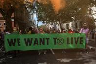 Activists from the climate protest group Extinction Rebellion holds up a large banner as they march through central London on September 1, 2020, at the start of their new season of "mass rebellions". - Climate protest group Extinction Rebellion will target Britain's parliament as part of "mass rebellions" starting from September 1. Other actions will take place around the country. (Photo by ISABEL INFANTES / AFP) (Photo by ISABEL INFANTES/AFP via Getty Images)