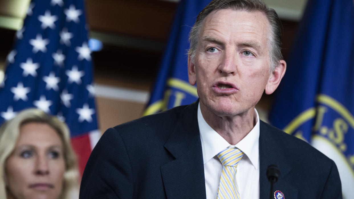 Rep. Paul Gosar speaks as Rep. Marjorie Taylor Greene looks on