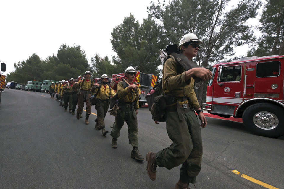A Hotshots fire crew walks in line to fight the wildfire in the Pacific Palisades area of Los Angeles, Sunday, May 16, 2021. (AP Photo/Ringo H.W. Chiu)