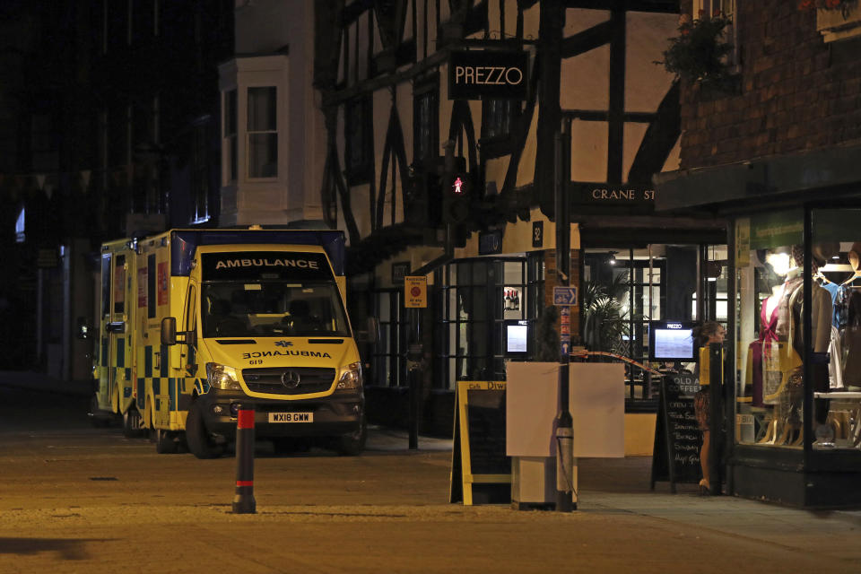 Ambulances are parked outside the Prezzo restaurant in Salisbury, Britain, where police closed roads as a "precautionary measure" after two people were taken ill from the restaurant, Sunday Sept. 16, 2018. Police closed roads and called a hazardous response team Sunday night after two people became ill at the restaurant in the English city where a Russian ex-spy and his daughter were poisoned with a chemical nerve agent. The conditions of a man and woman who got sick at the restaurant was under investigation. (Jonathan Brady/PA via AP)