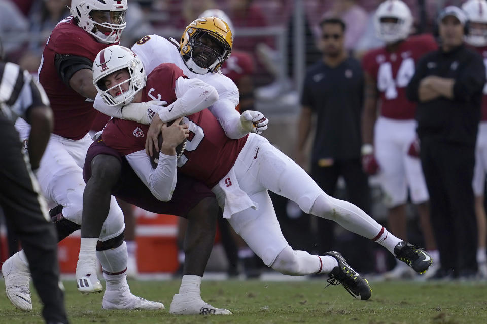 Stanford quarterback Tanner McKee, bottom, is tackled by Arizona State defensive lineman Travez Moore during the second half of an NCAA college football game in Stanford, Calif., Saturday, Oct. 22, 2022. (AP Photo/Jeff Chiu)