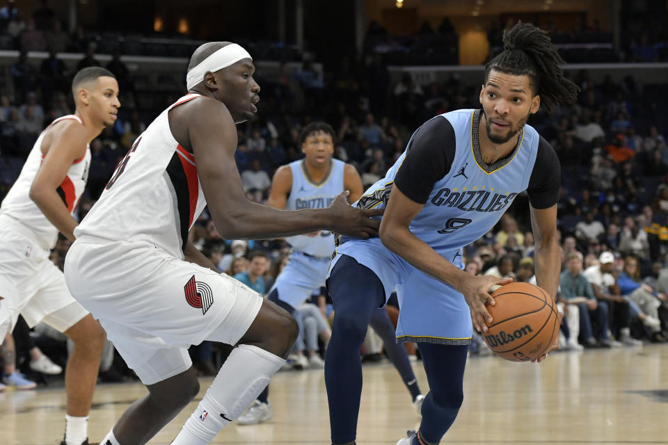 Memphis Grizzlies forward Ziaire Williams (8) works against Portland Trail Blazers center Duop Reath during the first half of an NBA basketball game Saturday, March 2, 2024, in Memphis, Tenn. (AP Photo/Brandon Dill)