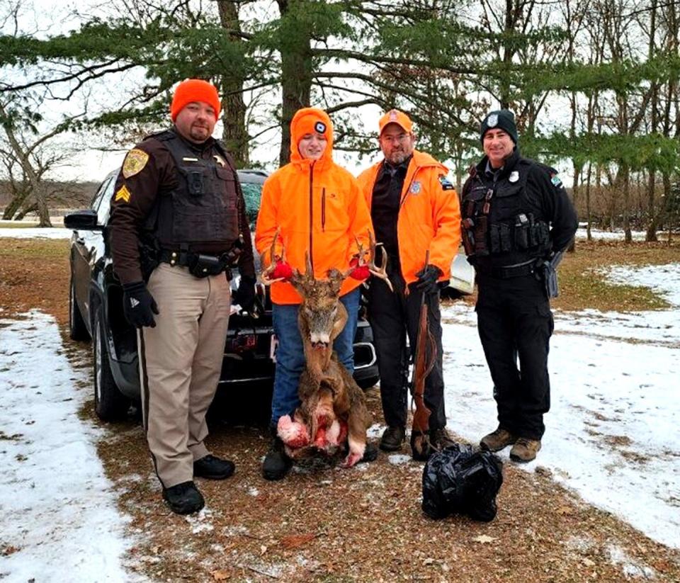 Garrett Diehm of Portage poses with the head of his trophy buck and law enforcement officers who worked to help recover the stolen deer.