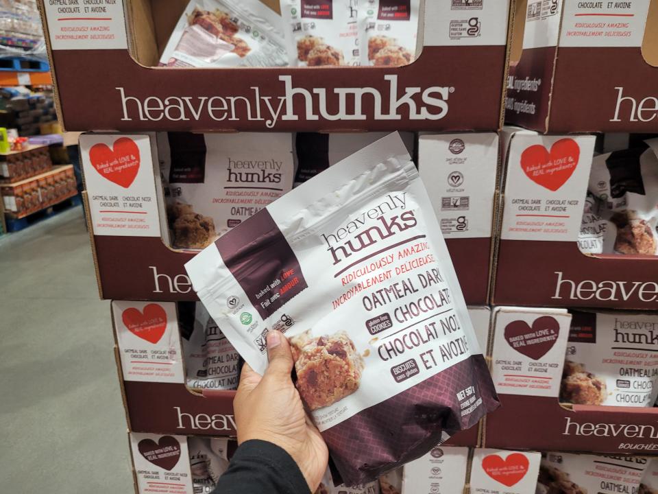 hand holding bulk bag of heavenly hunks in costco