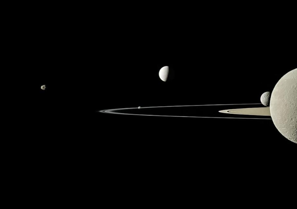 The Cassini spacecraft took this image showing part of Saturn’s rings, made of billions of small chunks of ice and rock, and five of its moons. <a href="https://www.nasa.gov/image-feature/jpl/group-portrait" rel="nofollow noopener" target="_blank" data-ylk="slk:NASA/JPL-Caltech/Space Science Institute;elm:context_link;itc:0;sec:content-canvas" class="link ">NASA/JPL-Caltech/Space Science Institute</a>