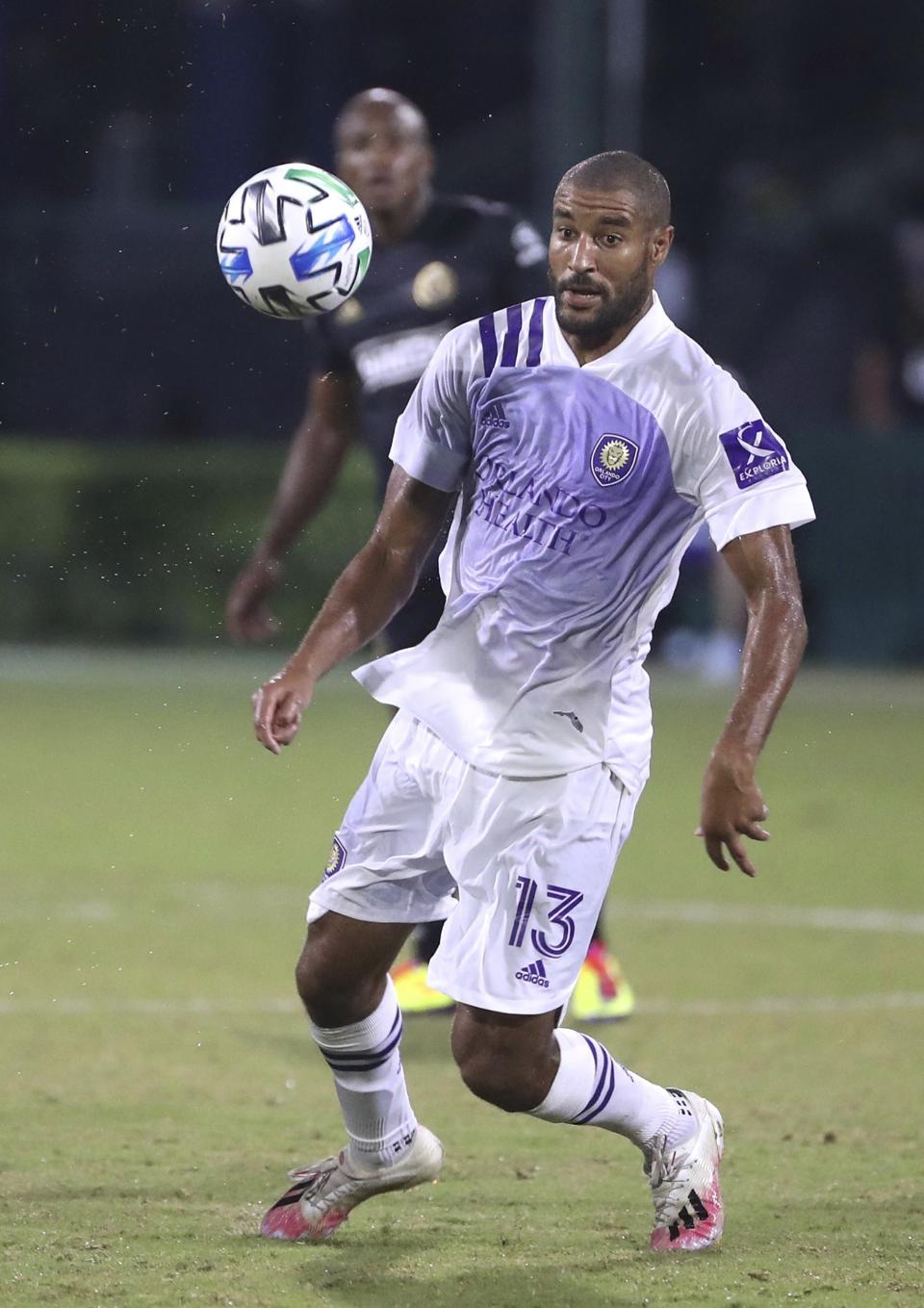 Orlando City's Tesho Akindele controls the ball during an MLS Is Back tournament soccer game against the Philadelphia Union in Orlando, Fla., Monday, July 20, 2020. (Stephen M. Dowell/Orlando Sentinel via AP)