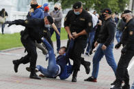 Police officers detain a protester during a rally against the removal of opposition candidates from the presidential elections in Minsk, Belarus, Tuesday July 14, 2020. Election authorities in Belarus on Tuesday barred two main rivals of authoritarian leader Alexander Lukashenko from running in this summer's presidential election. (AP Photo/Sergei Grits)