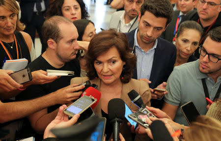 Spain's deputy prime minister Carmen Calvo speaks to journalists at parliament before a vote on the Socialist's government's plans to move the remains of former dictator Francisco Franco from the giant mausoleum at "The Valley of the Fallen", in Madrid, Spain, September 13, 2018. REUTERS/Sergio Perez