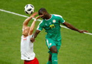 Soccer Football - World Cup - Group H - Poland vs Senegal - Spartak Stadium, Moscow, Russia - June 19, 2018 Poland's Michal Pazdan in action with Senegal's Moussa Konate REUTERS/Kai Pfaffenbach