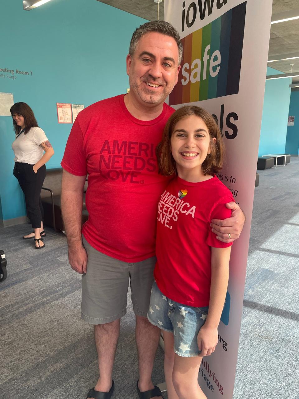 Christopher White (left) standing next to daughter Annie White during a drag story hour Sunday, May 21 at the Des Moines Central Public Library.