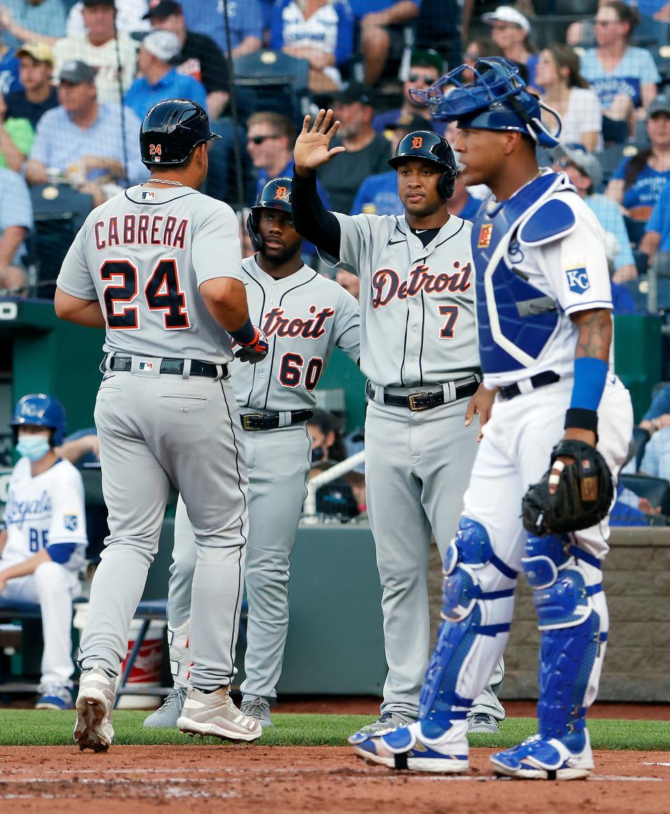 Miguel Cabrera of the Detroit Tigers is congratulated by Akil Baddoo and Jonathan Schoop after scoring during the 1st inning of the game against the Kansas City Royals at Kauffman Stadium in Kansas City, Missouri, on Monday, June 14, 2021.