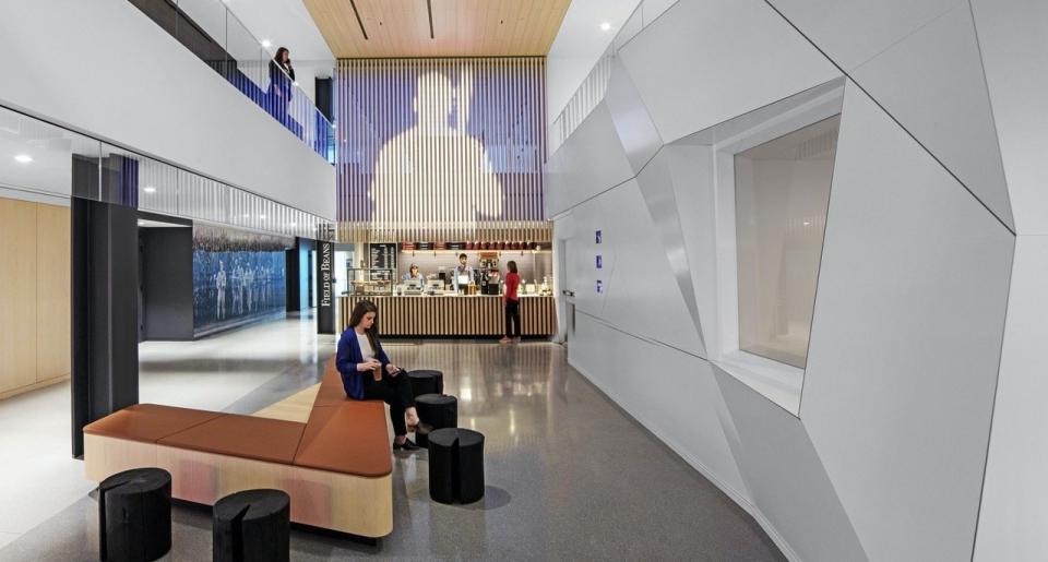 Concourse central volume (complete with its own coffee bar) inside the Studio Architecture-designed MLB headquarters.