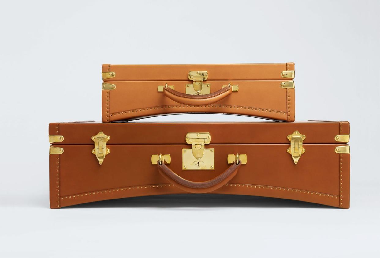 brown leather luggage with gold handles