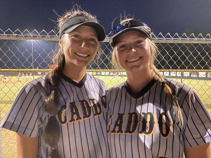 Caddo junior third baseman Jaycie Nichols, left, and senior shortstop Kadey Lee McKay smiles after a doubleheader sweep at the Dale-Tecumseh softball tournament on Thursday.