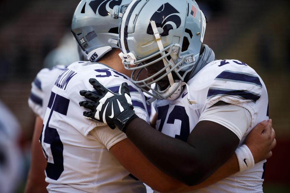 Kansas State offensive linemen Hayden Gillum (55) and Christian Duffie (73) talk before last year's game against Iowa State in Ames, Iowa.