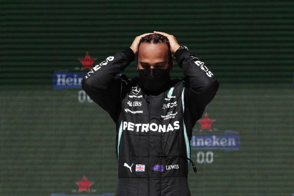 Mercedes driver Lewis Hamilton of Britain stands on the podium after winning the Portugal Formula One Grand Prix at the Algarve International Circuit near Portimao, Portugal, Sunday, May 2, 2021. (AP Photo/Manu Fernandez)