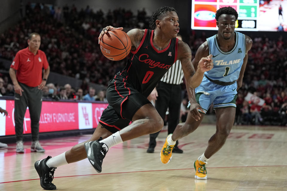 Houston guard Marcus Sasser (0) drives past Tulane guard Sion James (1) during the second half of an NCAA college basketball game, Wednesday, Feb. 22, 2023, in Houston. (AP Photo/Kevin M. Cox)