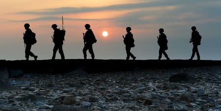 South Korean marines patrol along a bank of a shore on Yeonpyeong island just south of Northern Limit Line (NLL), South Korea, August 23, 2015. REUTERS/Min Gyeong-seok/ News1