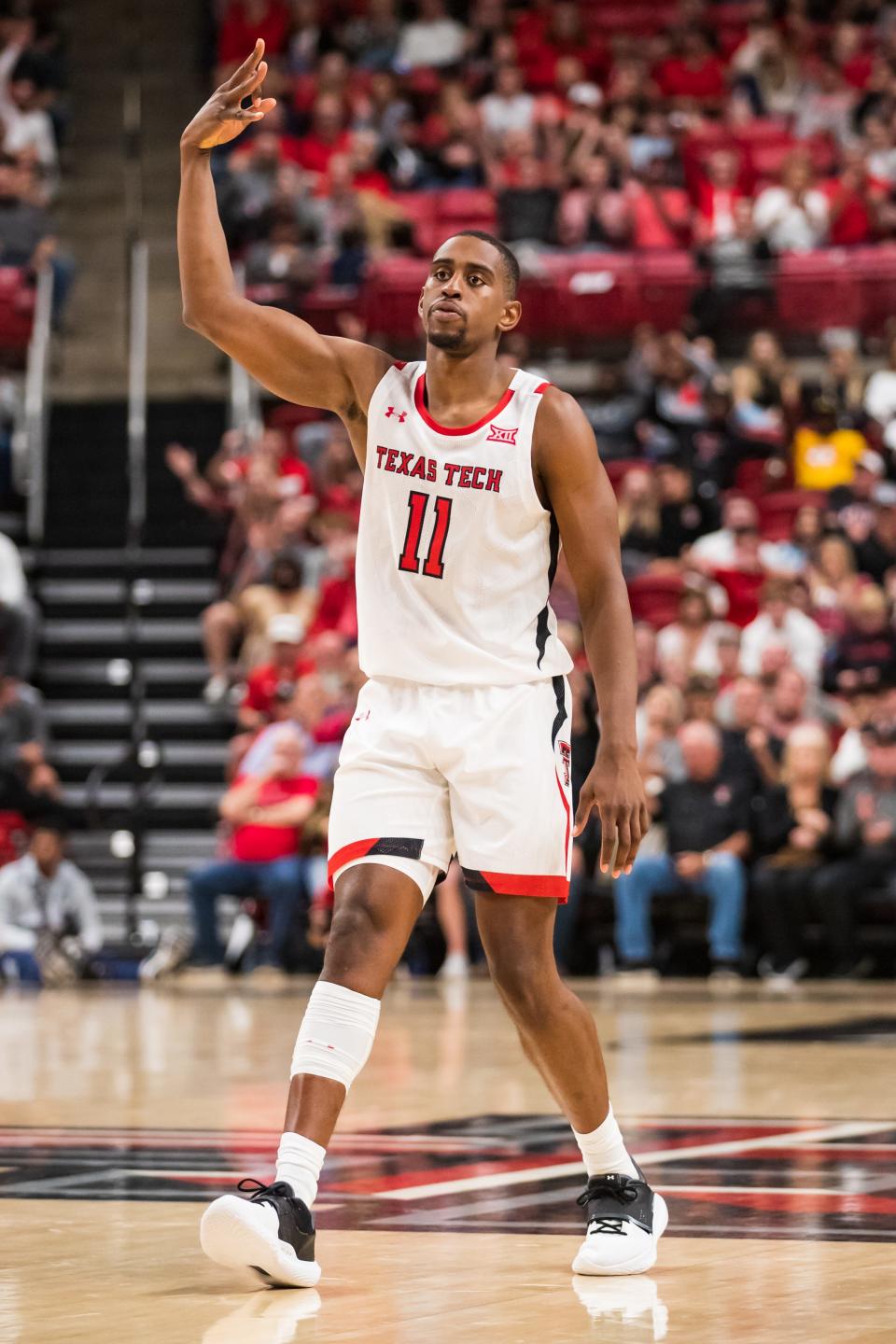 LUBBOCK, TEXAS - NOVEMBER 09: Forward Bryson Williams #11 of the Texas Tech Red Raiders signals after making a three-pointer during the first half of the college basketball game against the North Florida Ospreys at United Supermarkets Arena on November 09, 2021 in Lubbock, Texas. (Photo by John E. Moore III/Getty Images) ORG XMIT: 775730441 ORIG FILE ID: 1352366375