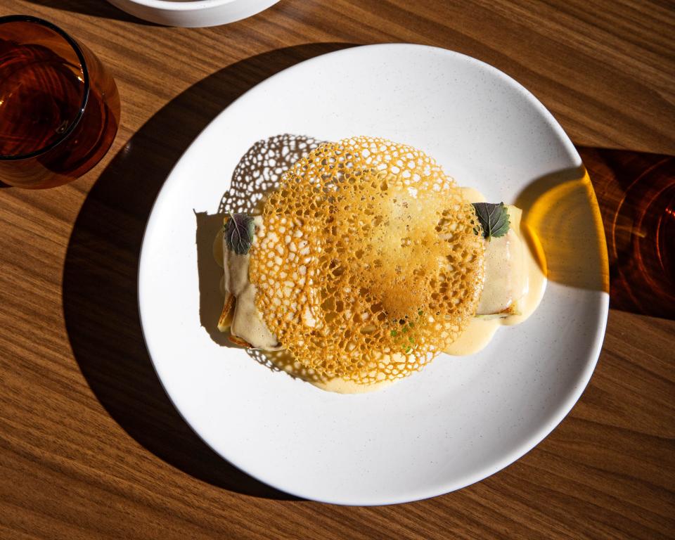 Scallop-stuffed crepe, nam prik blanquette and laced tuile is served at Bad Idea.
