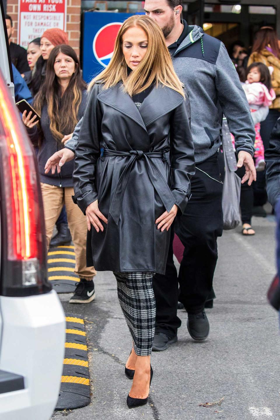 In A Leather Trench Coat, Dress And Pumps