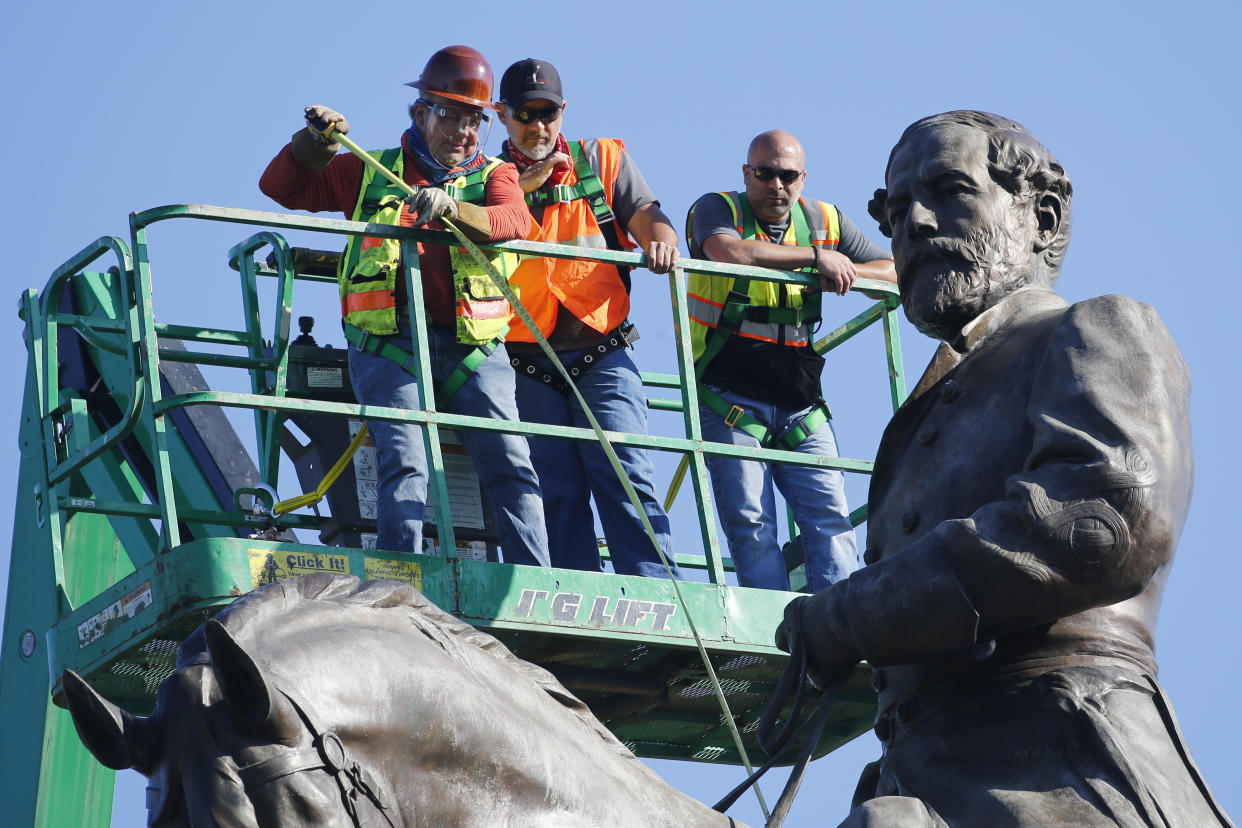 An inspection crew from the Virginia Department of General Services takes measurements as they inspect the statue of Confederate Gen. Robert E. Lee on Monument Avenue June 8, 2020, in Richmond, Virginia. Gov. Ralph Northam has ordered the removal of the statue. (AP Photo/Steve Helber) (Photo: ASSOCIATED PRESS)