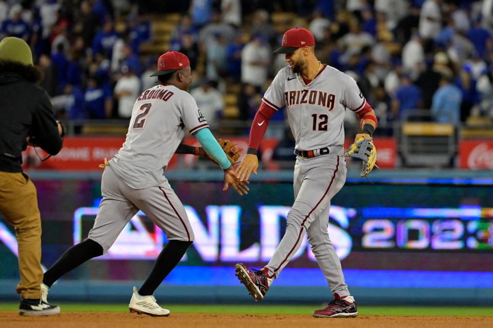 Arizona Diamondbacks left fielder Lourdes Gurriel Jr. (12) and shortstop Geraldo Perdomo (2) celebrate after defeating the Los Angeles Dodgers in Game 2 of the NLDS at Dodger Stadium.