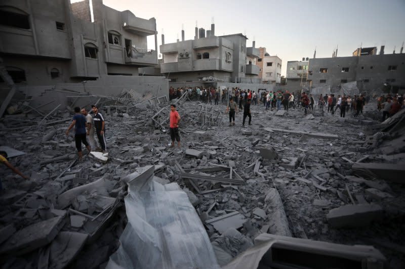 People search for victims following an Israeli strike on houses in Rafah, in the southern Gaza Strip, on Monday. Photo by Ismael Mohamad/UPI