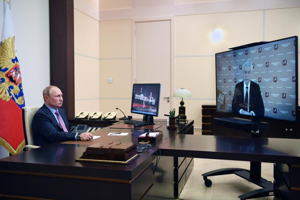 Russian President Vladimir Putin listens to Moscow Mayor Sergei Sobyanin during their meeting via teleconference at the Novo-Ogaryovo residence outside Moscow, Russia, Wednesday, May 27, 2020. (Alexei Nikolsky, Sputnik, Kremlin Pool Photo via AP)