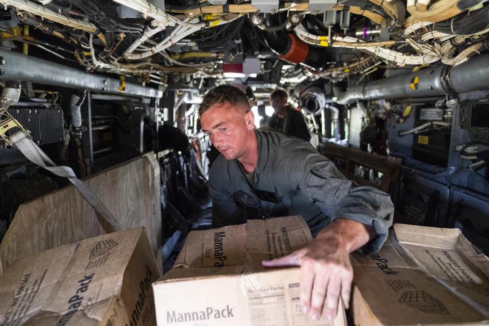 U.S. Marine Corps Lance Cpl. Brandon Oldham, unloads food from a VM-22 Osprey at Jeremie Airport, Saturday, Aug. 28, 2021, in Jeremie, Haiti. The VMM-266, "Fighting Griffins," from Marine Corps Air Station New River, from Jacksonville, N.C., are flying in support of Joint Task Force Haiti after a 7.2 magnitude earthquake on Aug. 22, caused heavy damage to the country. (AP Photo/Alex Brandon)