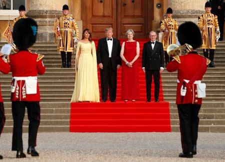 British Prime Minister Theresa May and her husband Philip stand together with U.S. President Donald Trump and First Lady Melania Trump at the entrance to Blenheim Palace, where they are attending a dinner with specially invited guests and business leaders, near Oxford, Britain, July 12, 2018. REUTERS/Kevin Lamarque